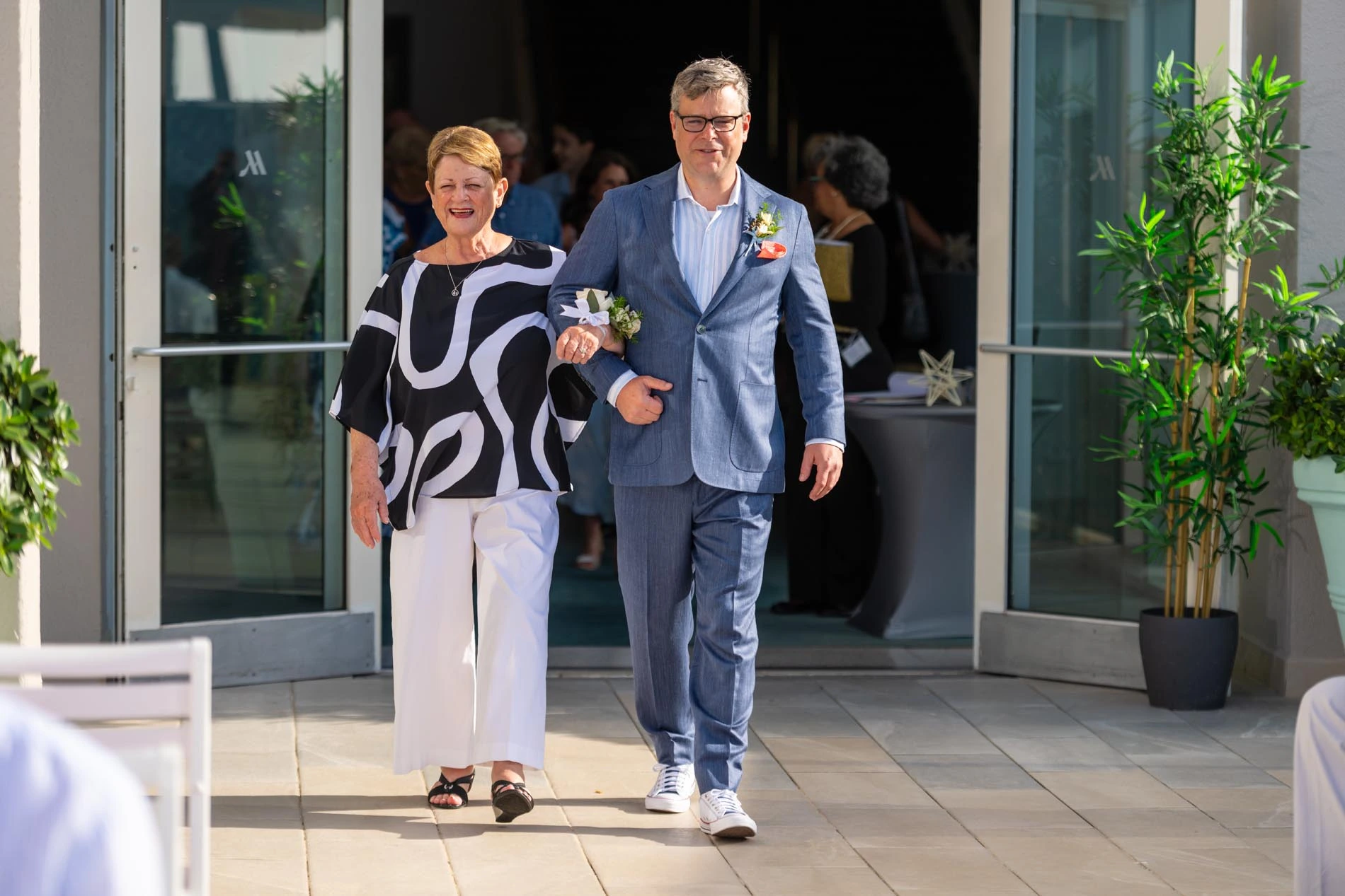 Groom walking toward the altar with his mom