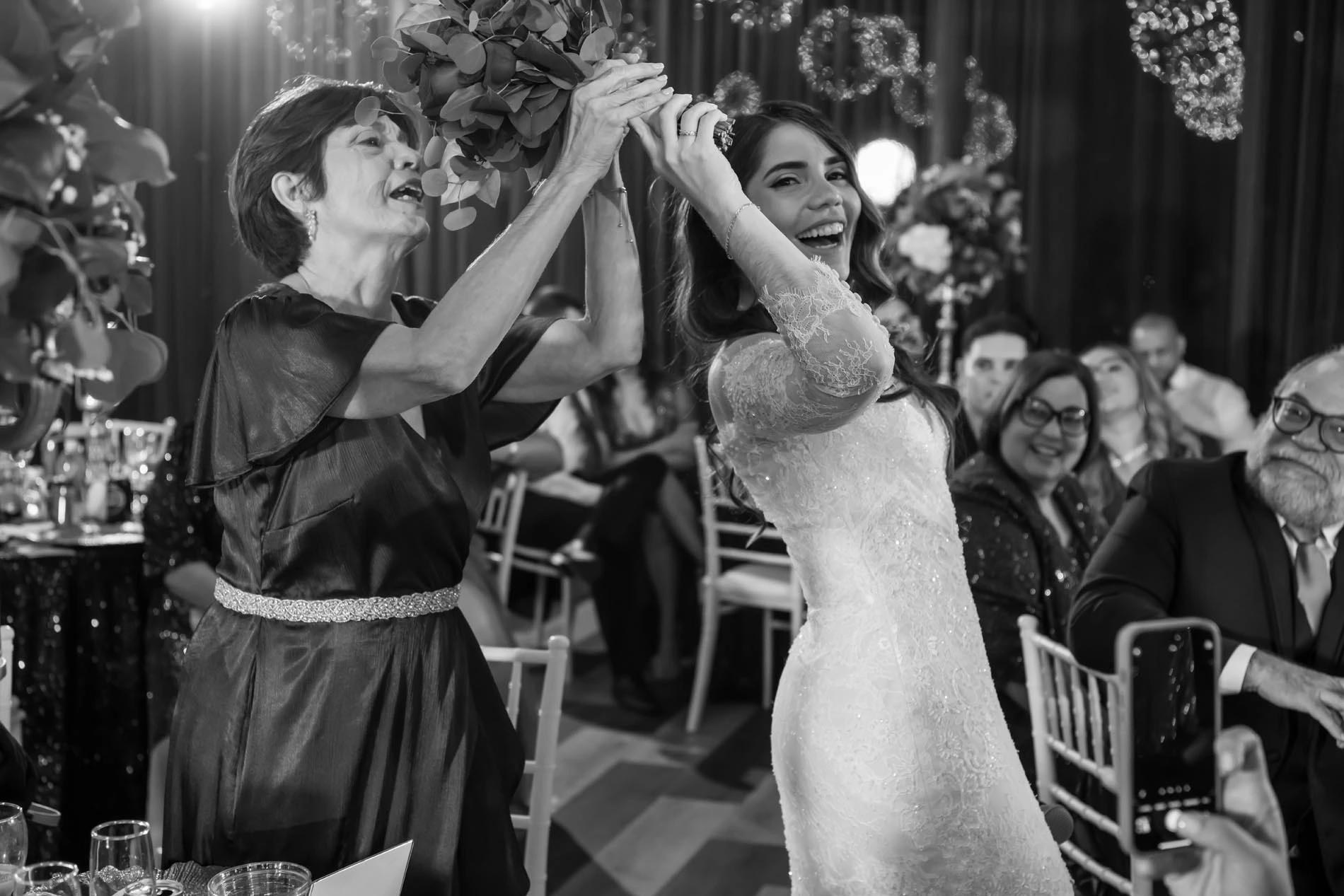 Bride giving her bouquet to her mom