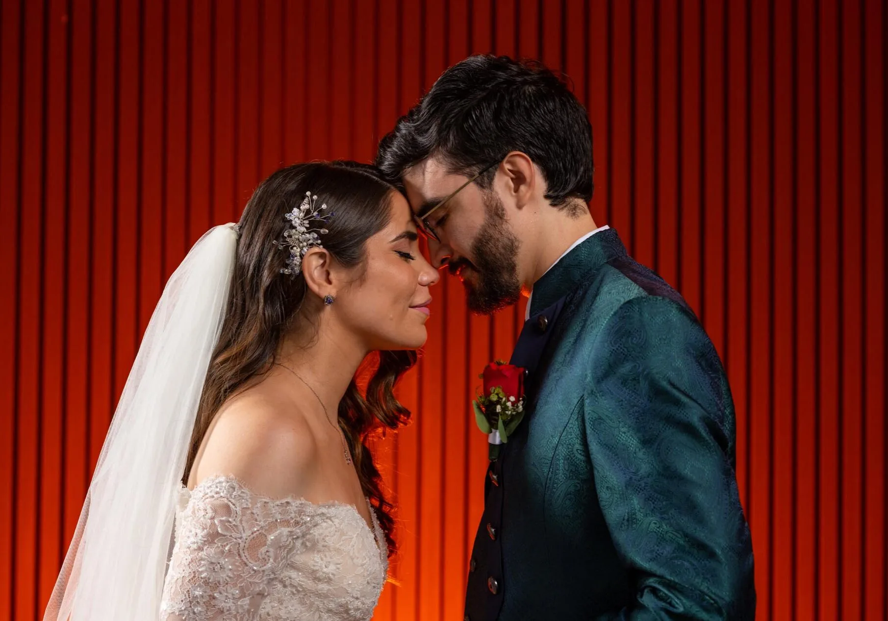 Newlyweds with their eyes closed touching forehead to forehead