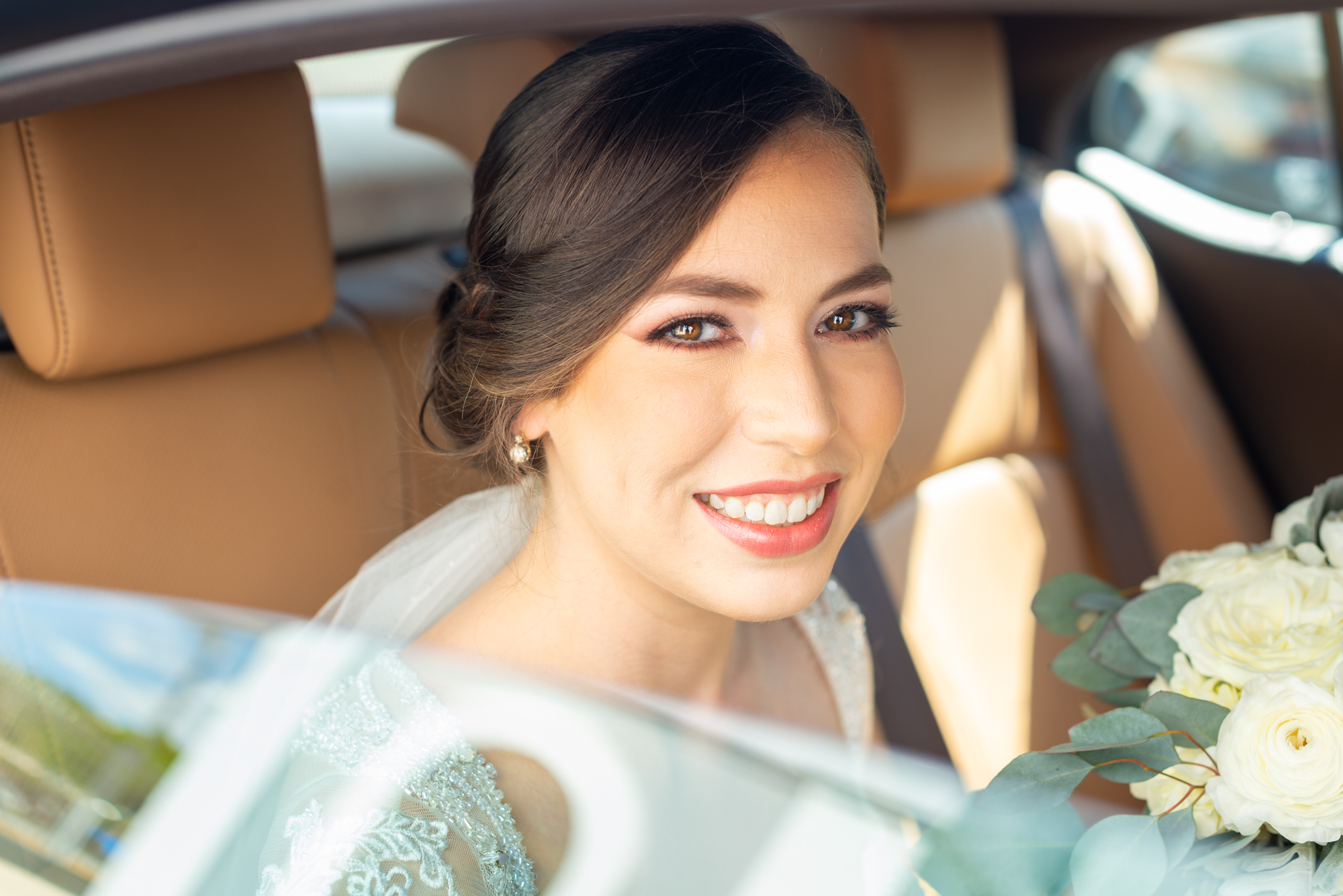 Beautiful bride waiting in car
