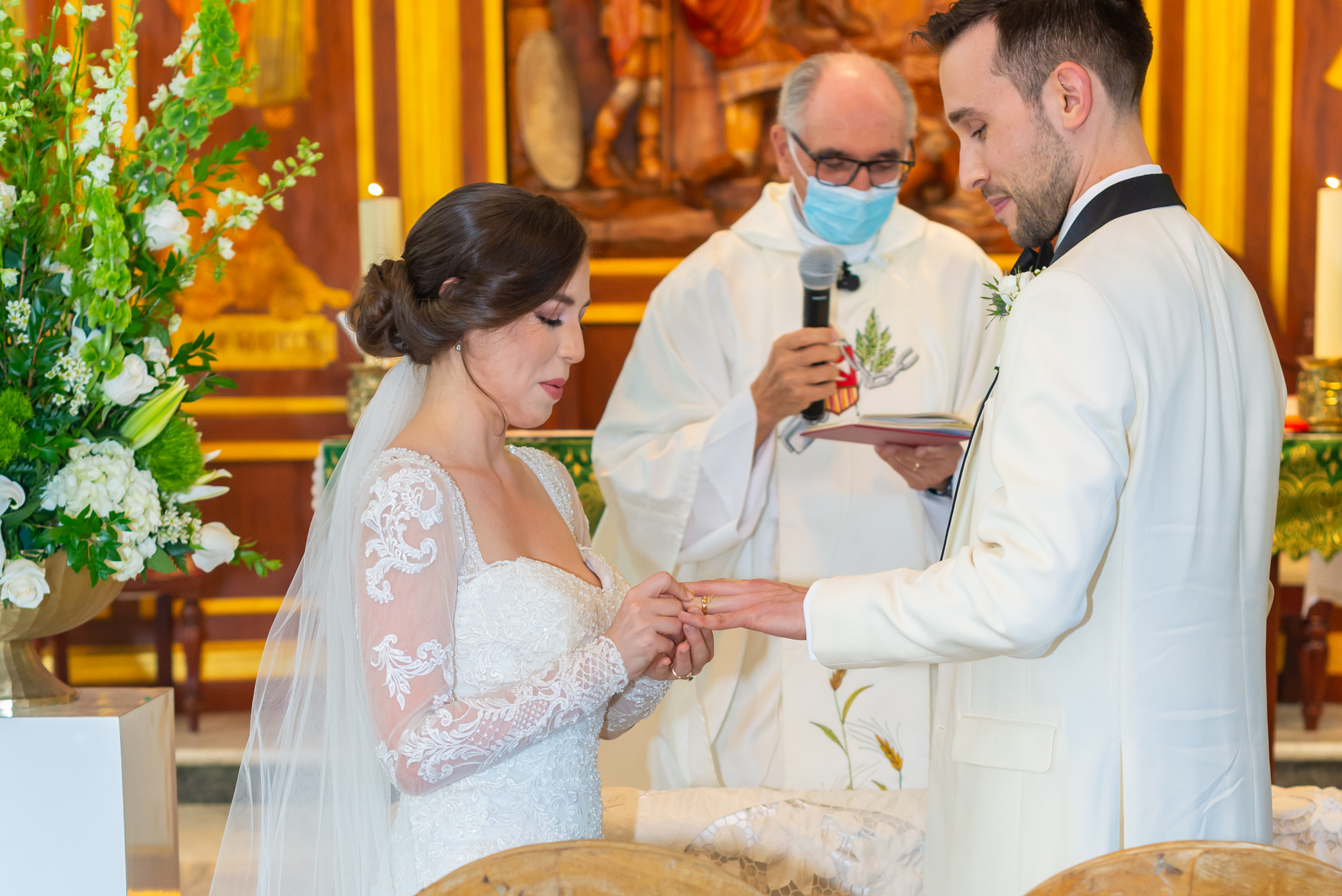Bride puts ring on groom's finger