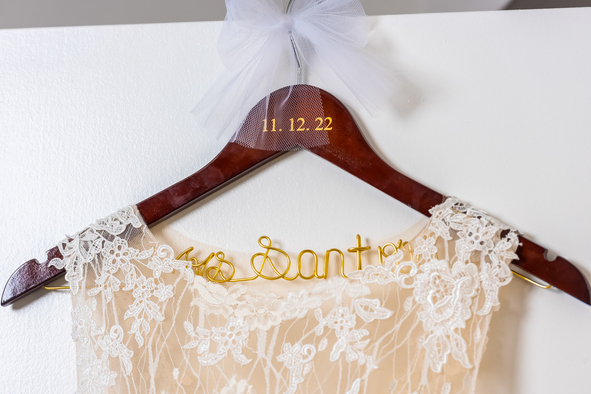 Detail of wedding dress on decorated hanger