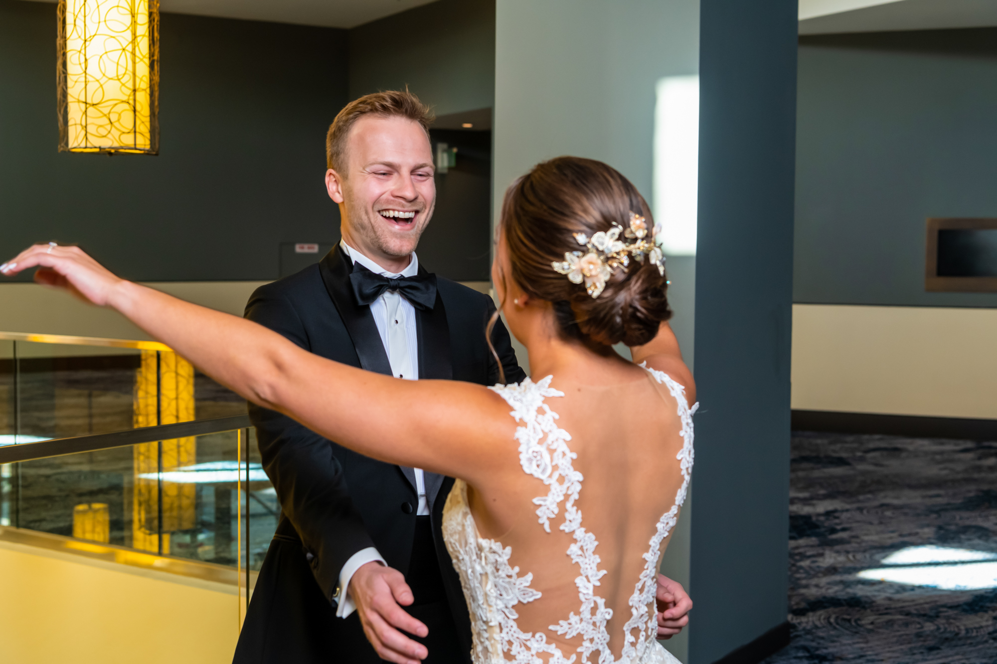 Groom smiles from ear to ear when seeing her bride for first time