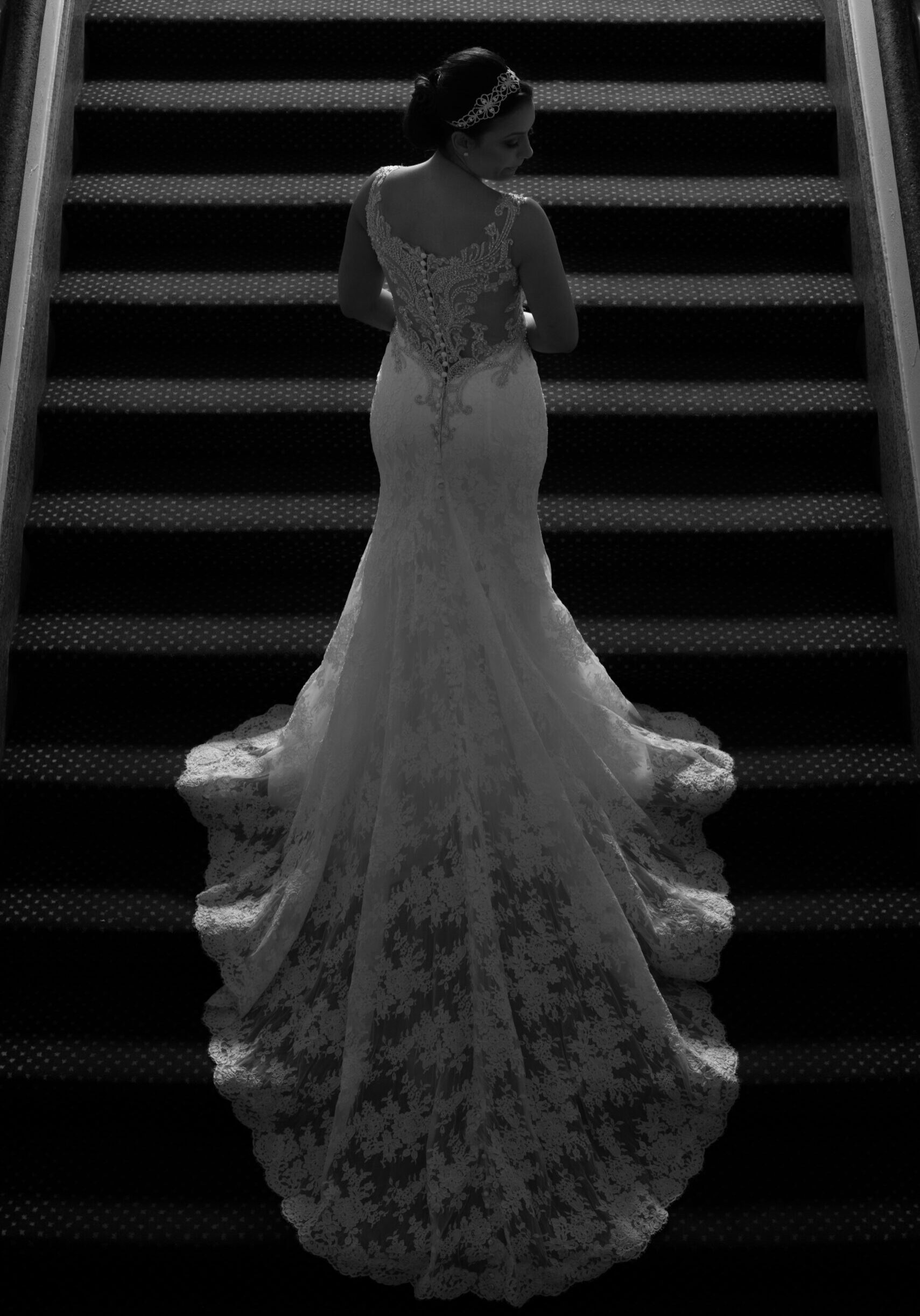 Bride in dramatic lighting on a stair at Antiguo Casino de Ponce