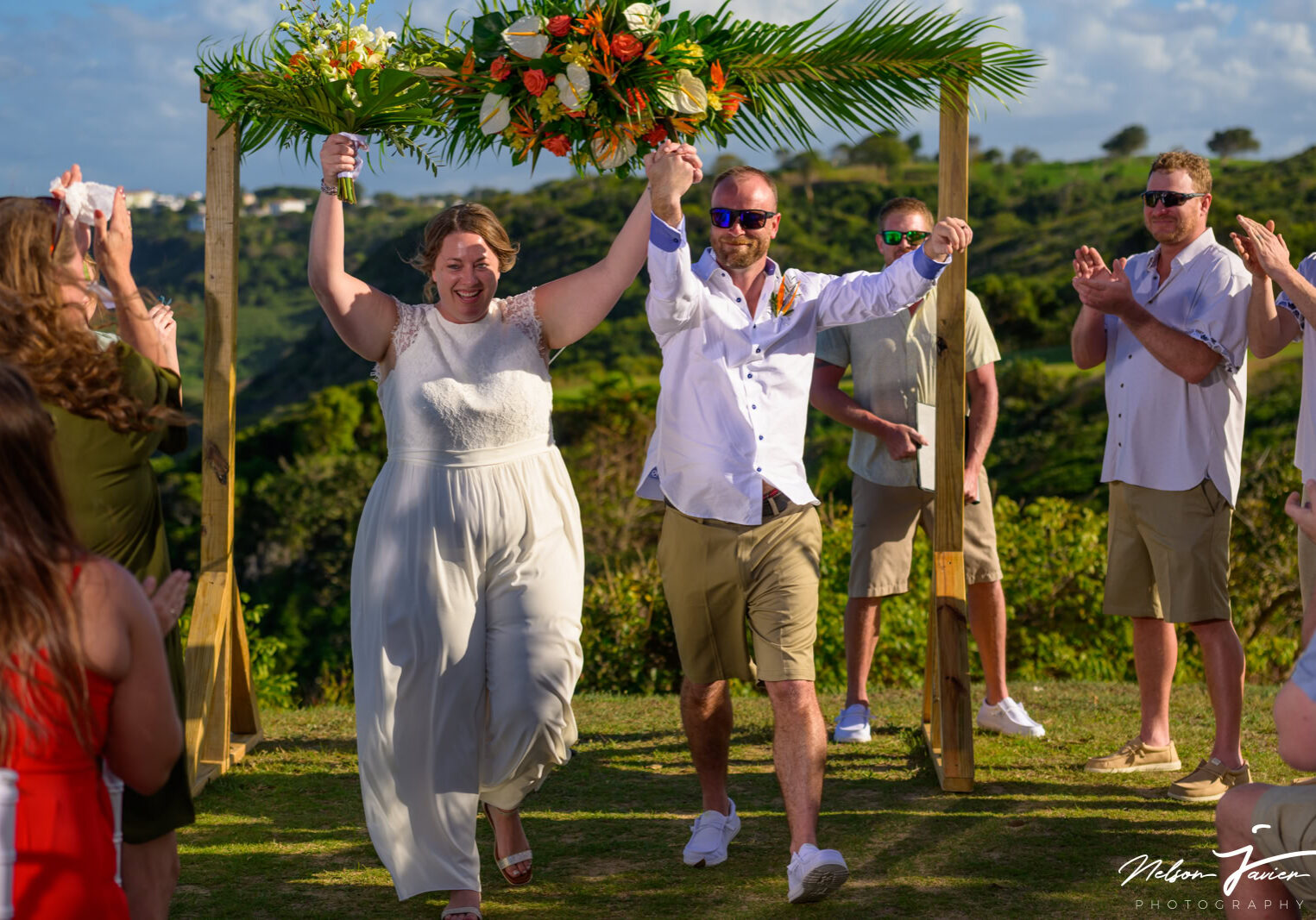 Happy couple with hands up celebrating their wedding at Royal Isabela